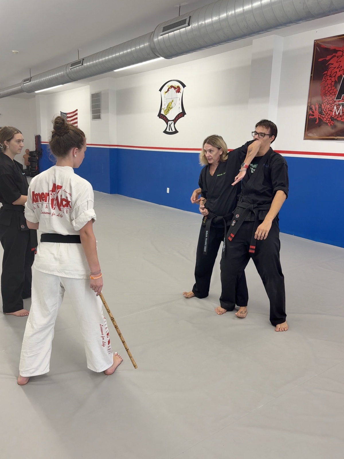 An AmeriKick instructor demonstrating a partner technique while students watch